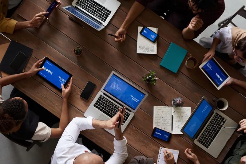 Mannai Information Technology KSA team collaborating around laptops and tablets